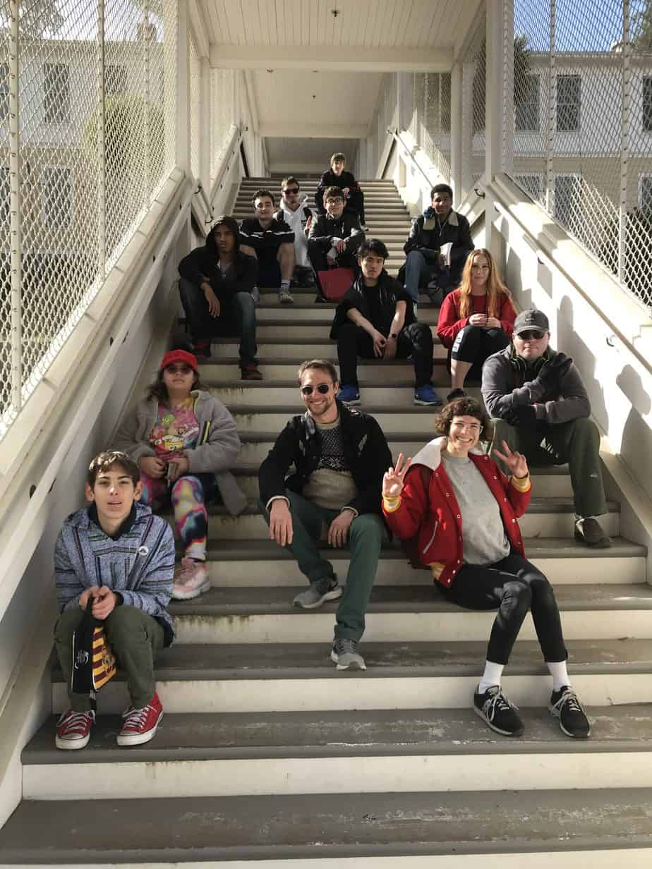 High school students sitting on staircase during field trip