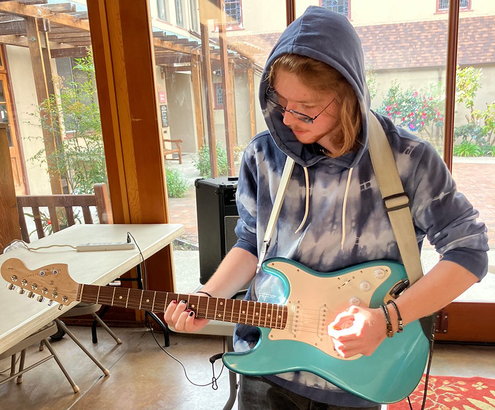 A student plays guitar